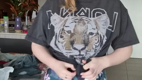 Woman in Floral Workout Leggings Trying on Outfits in Kitchen