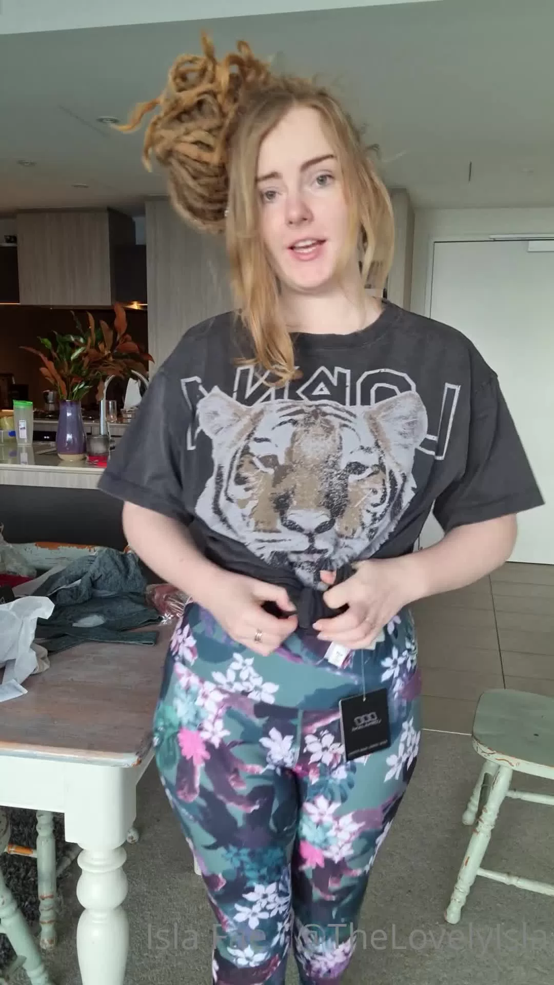 Woman in Floral Workout Leggings Trying on Outfits in Kitchen