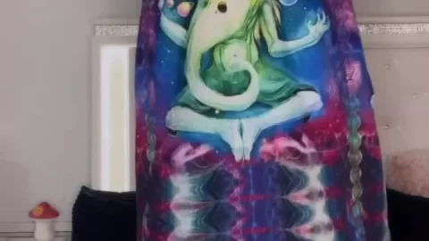 Young Caucasian Woman in Colorful Patterned Hoodie on Bed