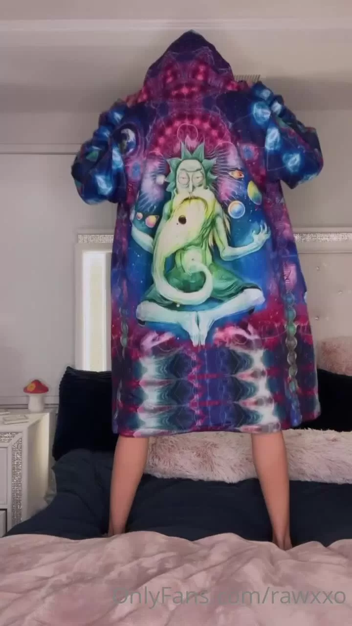 Young Caucasian Woman in Colorful Patterned Hoodie on Bed