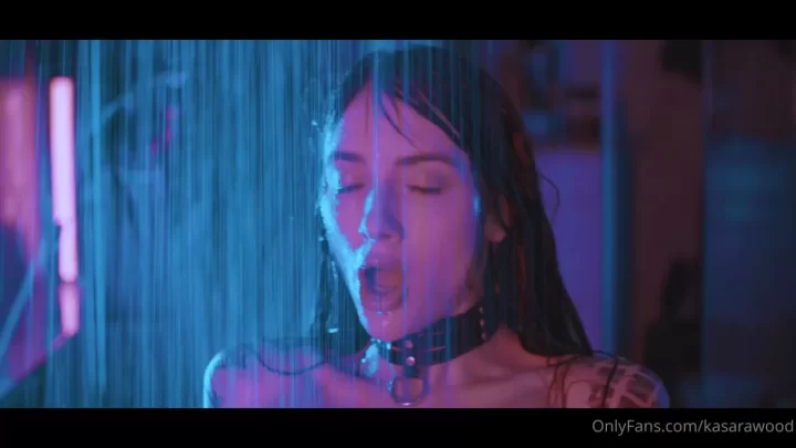 Brunette MILF jerks off and sucks black dildo under purple lights