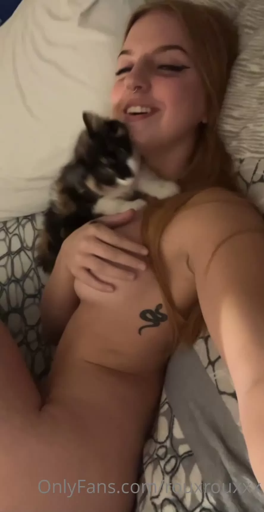 Redhead with Snake Tattoo and Calico Kitten on Bed Selfie