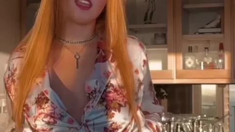 Redhead in Floral Satin Shirt Opening Her Top in the Kitchen