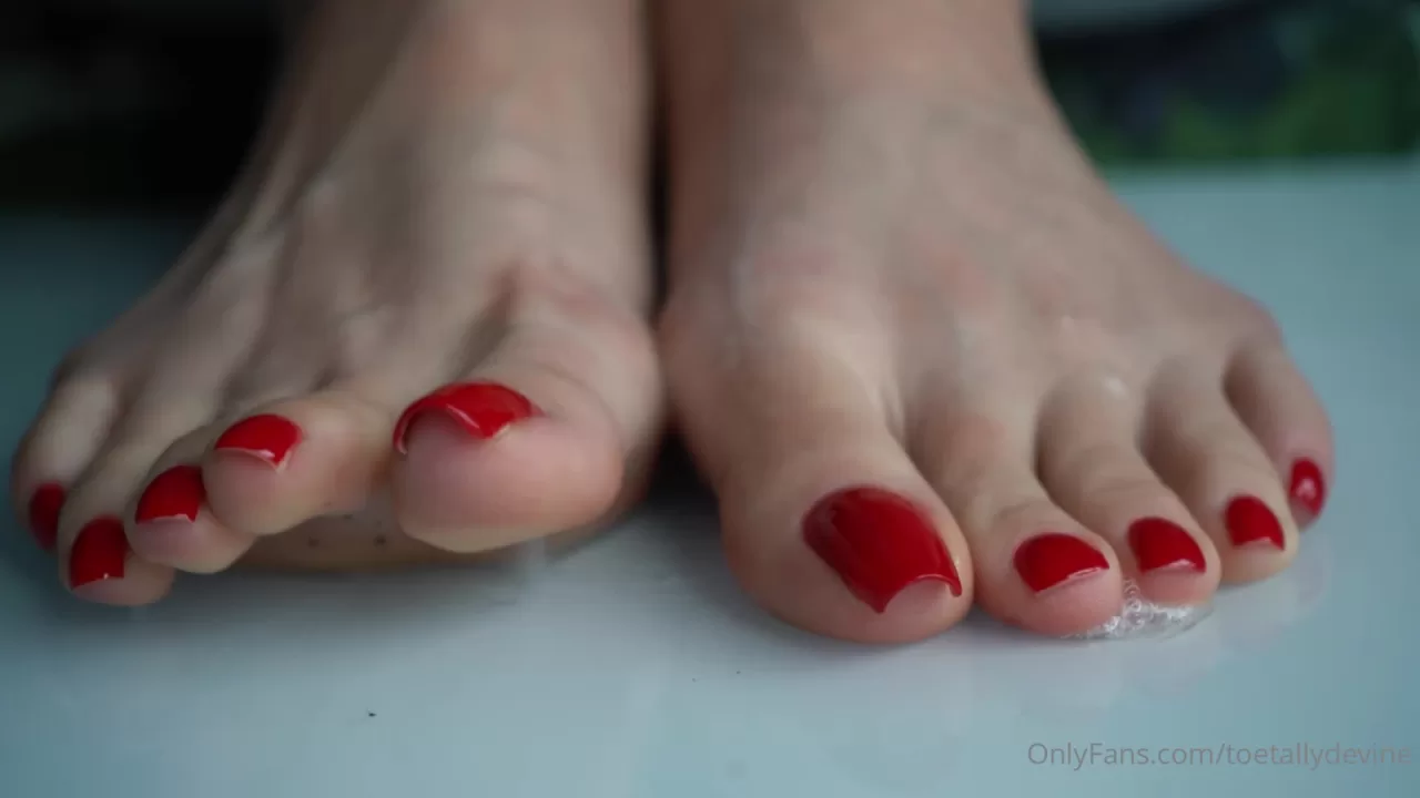 Bright Red Pedicured Feet Get Wet in Bathroom Close-Up
