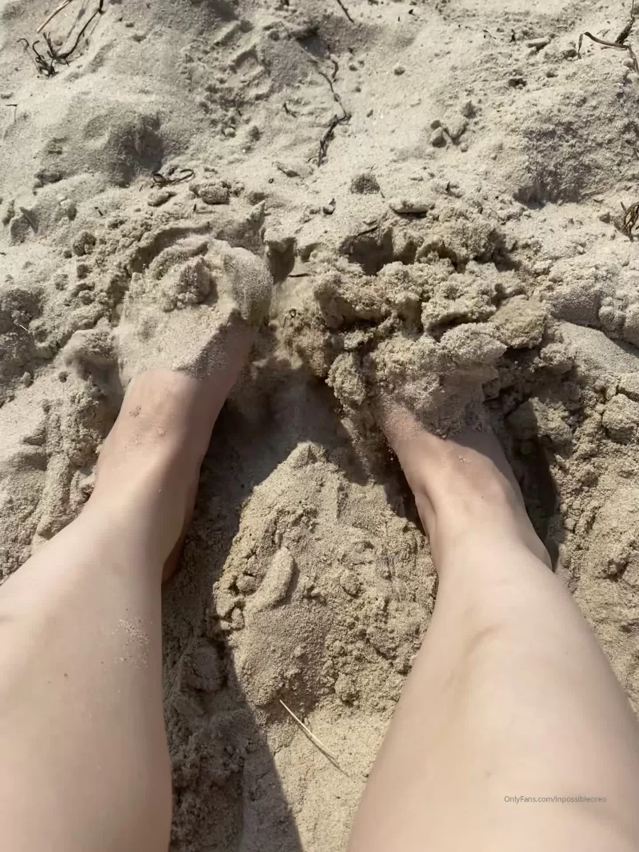 POV Beach Feet with Pink Nail Polish on Sand