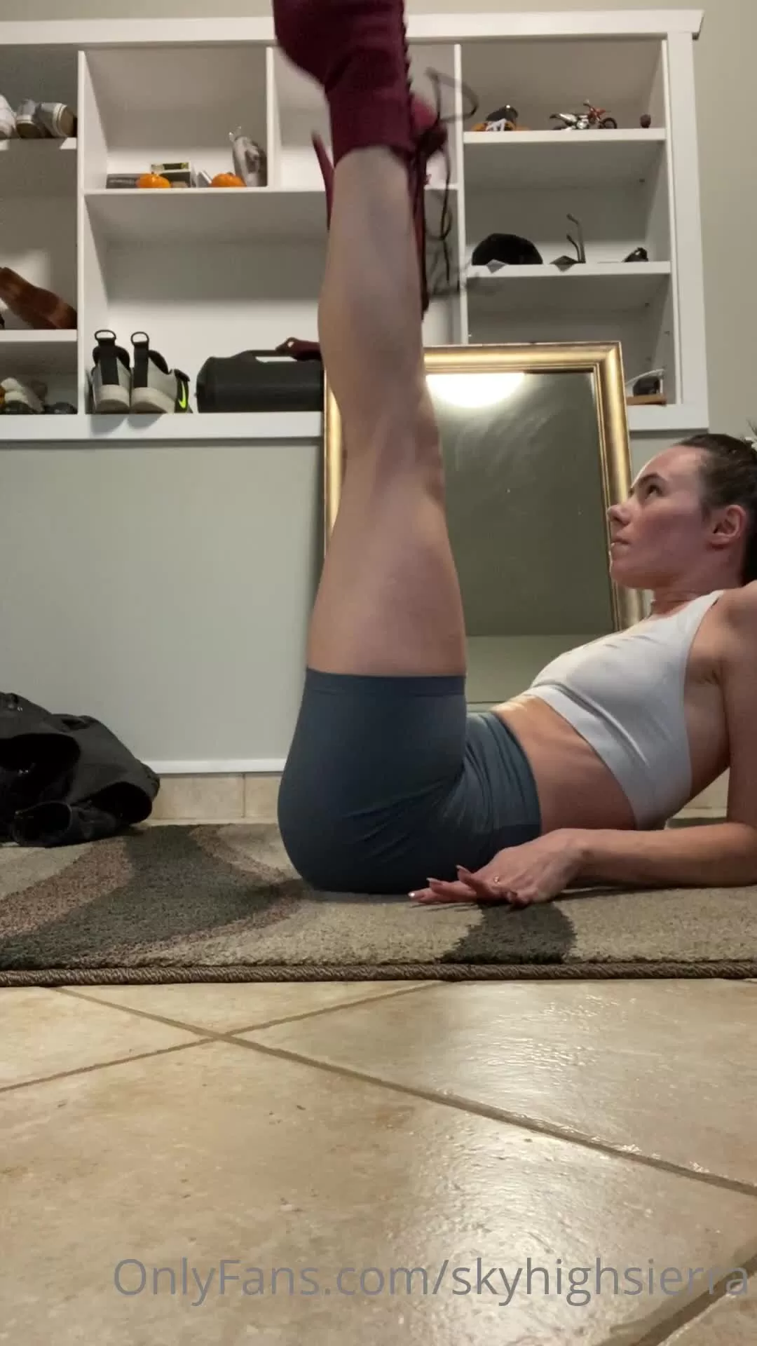 Athletic Woman in Maroon Platform Boots Doing Leg Lifts on Rug