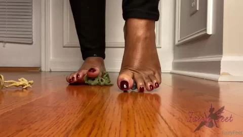 Dark-Skinned Bare Feet Crushing Plastic Toy Soldiers
