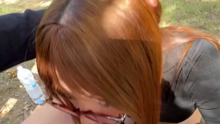 Redhead gives blowjob in forest with POV close-up