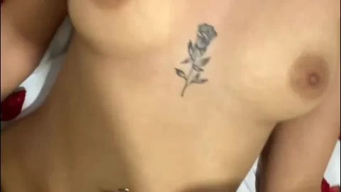 Latina with chest tattoo gives blowjob then jerks off on bed with rose