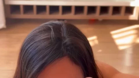 Brunette in red lipstick gives blowjob in living room with glass cabin