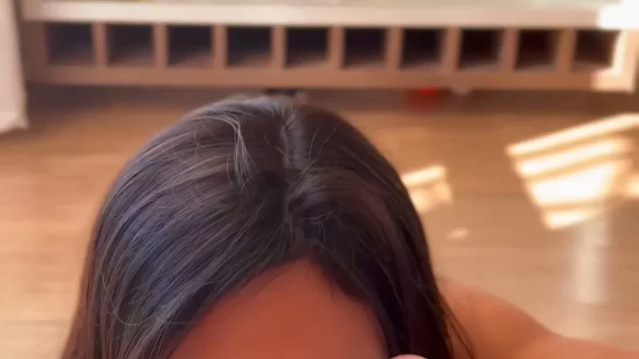 Brunette in red lipstick gives blowjob in living room with glass cabin