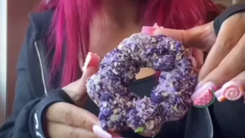 Pink-Haired Beauty Enjoying Donuts in Cozy Cafe Vibes