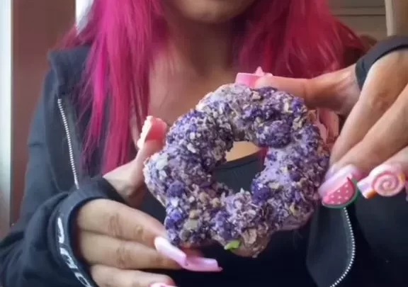 Pink-Haired Beauty Enjoying Donuts in Cozy Cafe Vibes