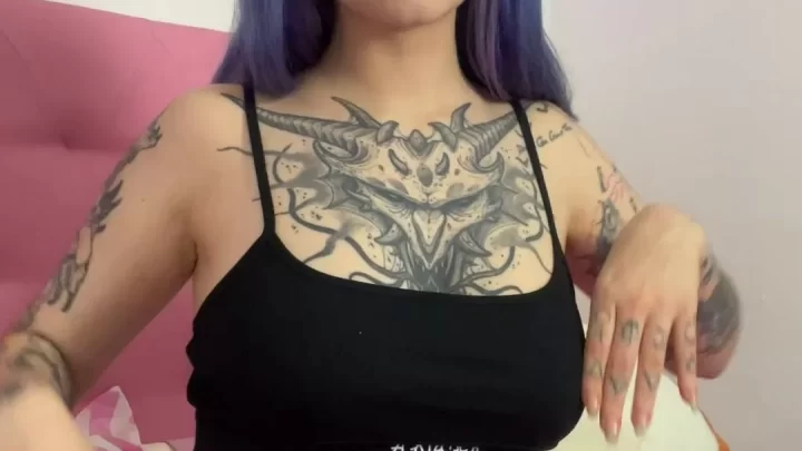 Tattooed pink-haired slim white teen poses seductively in neon bedroom