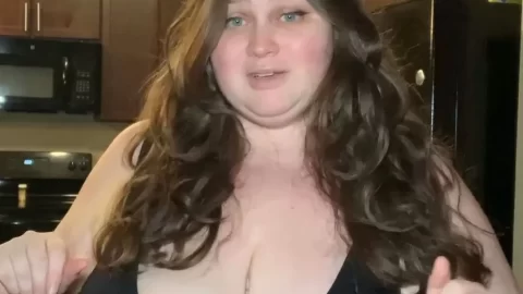 Brunette Plus-Size Woman Posing & Speaking in Kitchen