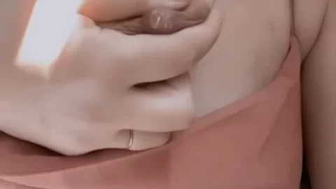 Blonde Girl Exposes Breast in Bedroom