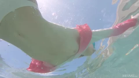 Blonde Girl Dives and Poses Underwater