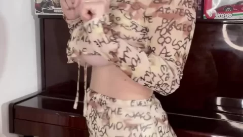 Teen girl plays with lollipop indoors