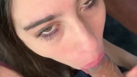 Brunette girl gives white guy a blowjob on bed
