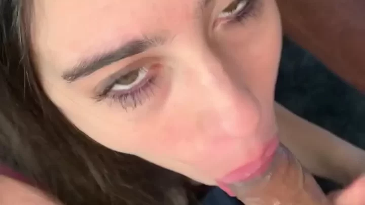 Brunette girl gives white guy a blowjob on bed