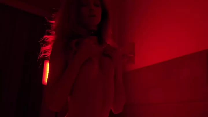 Blonde girl with neck tattoo gets intimate in red lit room