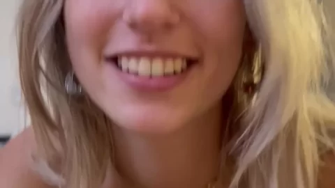 Blonde girl in white tank top gets up close