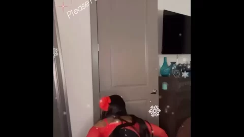 African American woman in red bodysuit shakes butt
