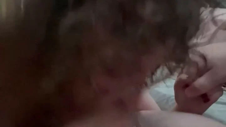 Brunette girl gives white guy blowjob on bed