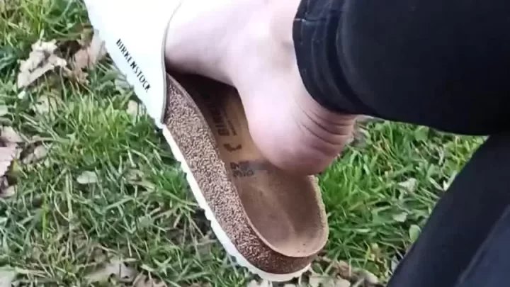 Slim 20s Girl with Black Toenails Puts on Shoes Outdoors