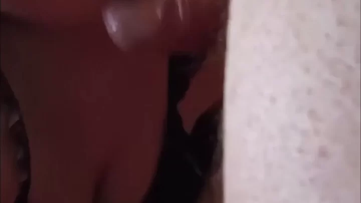 Brunette girl gives white guy blowjob on bed