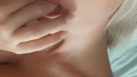 Blonde girl plays with herself on bed