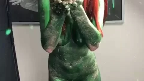 Redhead with green body paint gets playful
