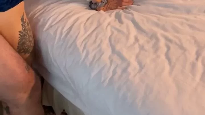 Brunette fucks herself on bed with white sheets