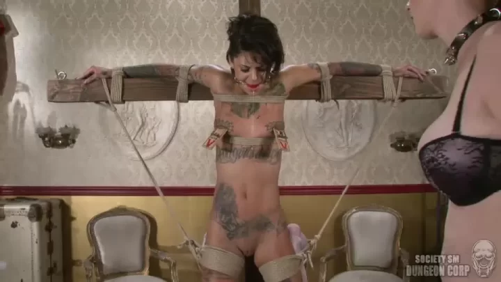 Tattooed brunette in bondage gets whipped by a muscular guy