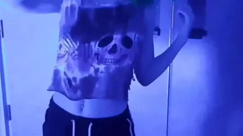 Blue-haired girl in cat ears dances and poses