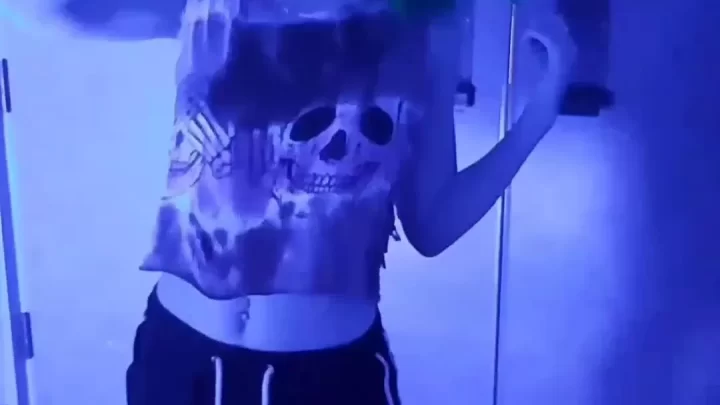 Blue-haired girl in cat ears dances and poses