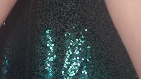 Slim 20s girl plays with sparkly fabric