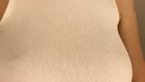 Blonde girl takes selfie while topless in bathroom