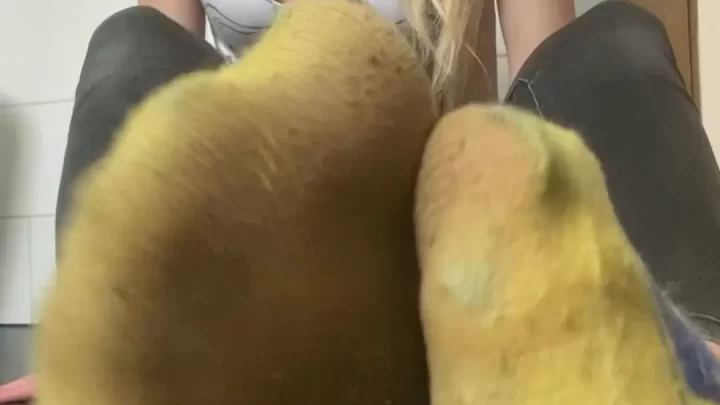 Blonde girl plays with shoe in bathroom