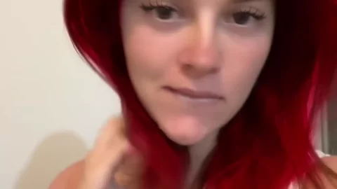 Redhead teen talks to cam, touches self
