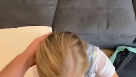 Blonde petite girl gives oral and handjob on couch