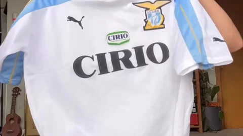 Teen with ponytail plays guitar naked then wears soccer jersey