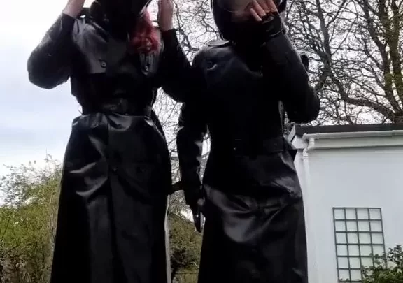 Redhead and brunette girls in black gear