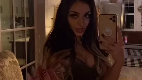 Brunette takes selfie while waving
