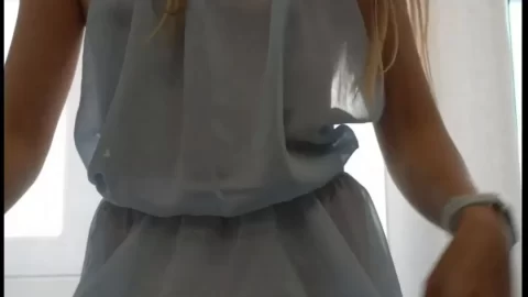 Brunette girl poses and moves in a dress