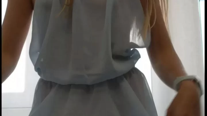 Brunette girl poses and moves in a dress