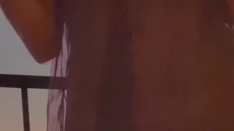 Brunette Girl Exposes Breasts on Balcony