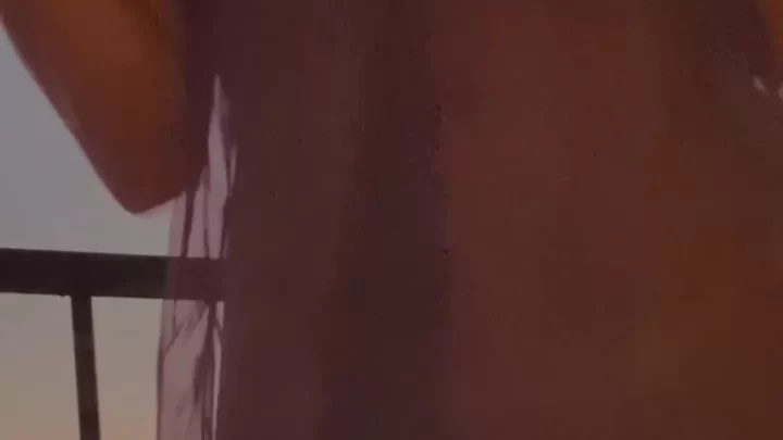 Brunette Girl Exposes Breasts on Balcony