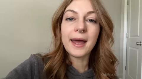 Redhead girl talks and smiles at camera
