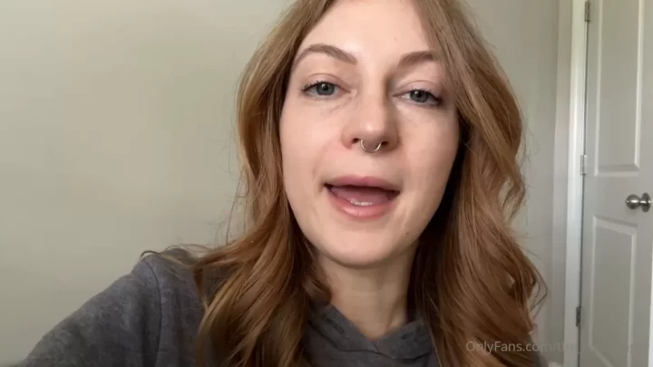 Redhead girl talks and smiles at camera